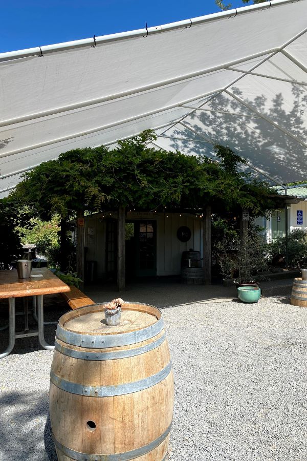 Porter Creek Tasting Tent with picnic table and wine barrel - great wineries in Sonoma